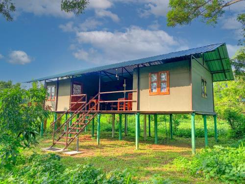 a house with a metal roof and a staircase at mango villa wilpattu in Nekattegama