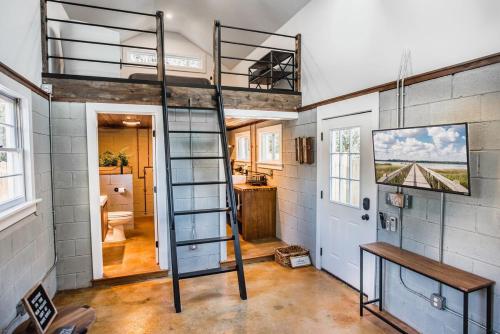 a loft bed in a tiny house at Olde Village Loft - Unique Park Circle Experience in Charleston