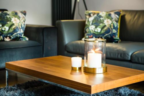 a living room with a coffee table with candles on it at Luxury Travel Emporium HG1 - 2 Luxury apartments with Parking Space - in town centre in Harrogate