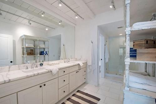a bathroom with two sinks and a large mirror at Expansive Ocean View, Private Balcony, Across from Beach in Carlsbad