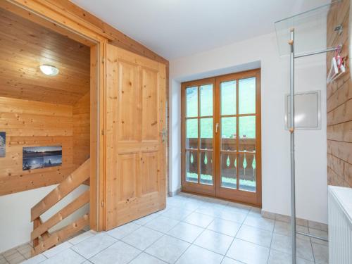 a bathroom with wooden walls and a sliding door at Haus Durchegg in Wagrain