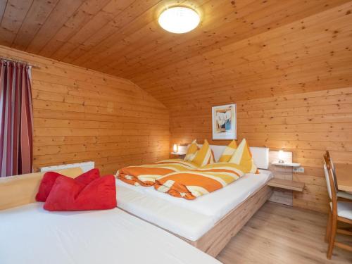 a bedroom with two beds in a wooden cabin at Haus Durchegg in Wagrain
