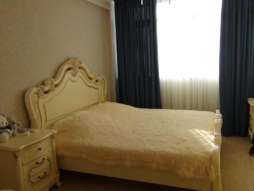 a bedroom with a bed and a mirror and a window at Apartment in Gagra in Gagra