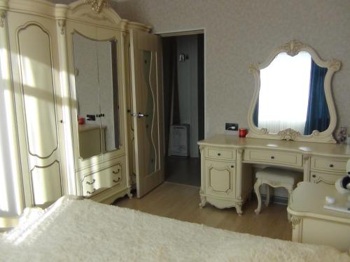 a white bathroom with a sink and a mirror at Apartment in Gagra in Gagra