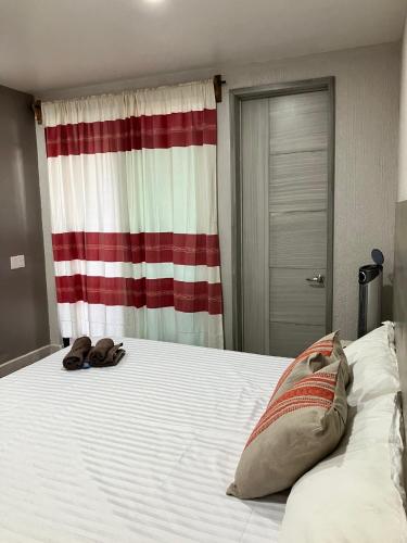a bed with two shoes sitting on top of it at Casa Biznaga in Oaxaca City