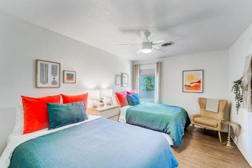 a bedroom with two beds and a chair at The Mariposa Wing B by Lodgewell - Spread your wings here in Austin