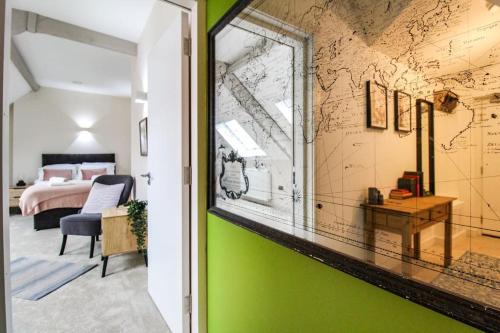 a room with a green wall with a map on it at Luxurious 2 Bedroom Apartment in City Centre in Nottingham