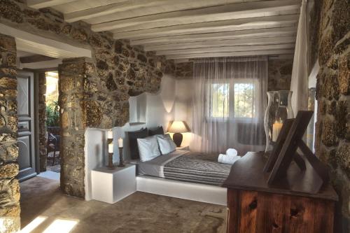 a bedroom with a bed in a room with a window at Villa Delilah - Paradise Estate Mykonos - Views, Party, Memories 2026 in Paraga