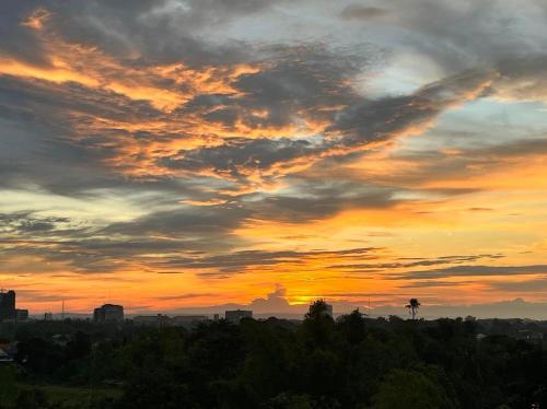 a sunset over a city with trees and buildings at 7F Majorca, Camella Manors Bacolod Condo in Bacolod