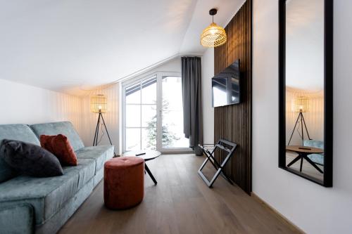 a living room with a couch and a table at CARPE SOLEM Jules in Obertauern
