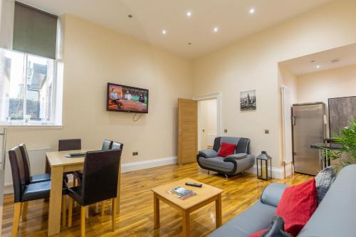 a living room with a couch and a table at New 2 bed apartment with stunning views of Arthur Seat Mountain in Edinburgh