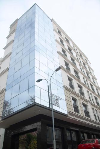 a tall glass building with a street light in front of it at H41 Luxury Suites in Belgrade