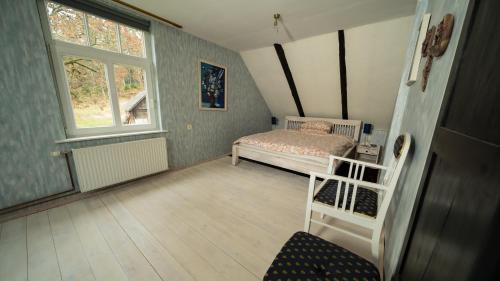 a small bedroom with a bed and a window at Avoti in Līgatne