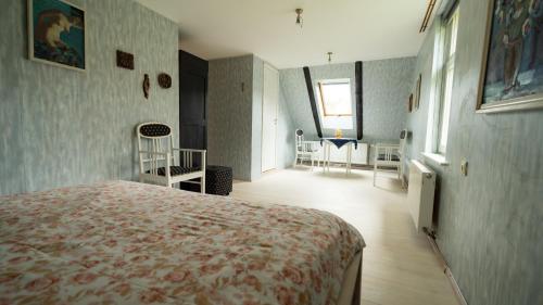 a bedroom with a bed and a room with chairs at Avoti in Līgatne