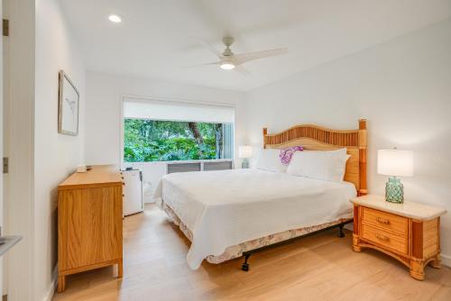 a bedroom with a large bed and a window at Pali Ke Kua #215 in Princeville