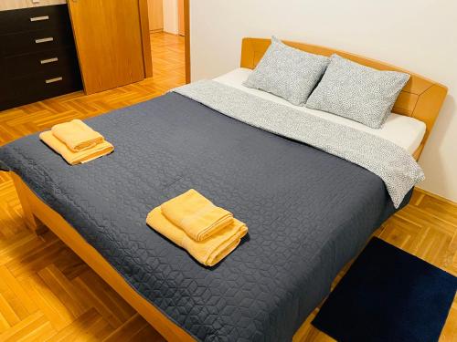 a bed with two yellow towels on top of it at Jolly Apartment - Belgrade in Belgrade