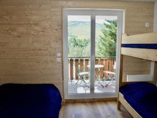 a bedroom with a bunk bed and a balcony at appartement ski au pied in Les Deux Alpes