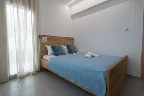 1 dormitorio con 1 cama grande con almohadas azules en Casa di Prios brand new renovated Villa in Gouves, en Gouves