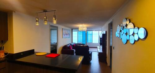 a kitchen and living room with a table and a couch at La mejor vista de la playa en Iquique in Iquique