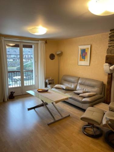 a living room with a couch and a table at Maison en pierre sur les Quais de la Dordogne in Argentat