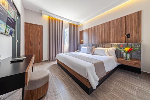 a hotel room with a large bed and a television at Casa Nou in Mexico City