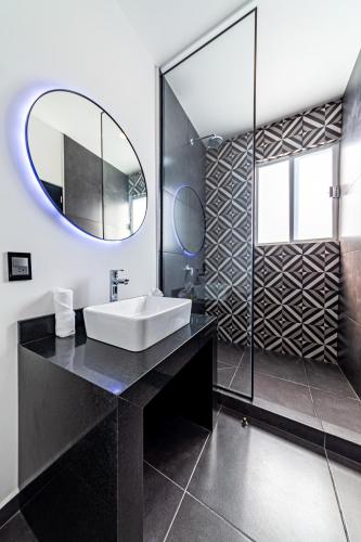 a bathroom with a sink and a mirror at Casa Nou in Mexico City