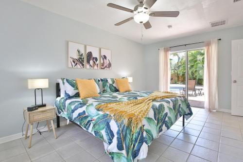 a bedroom with a bed and a ceiling fan at Fun, Resort-style Coastal Villa W Splash Pad! in Sarasota