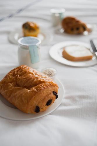 a table with plates of pastries on it at Monsieur Jean - Hôtel Particulier in Quebec City