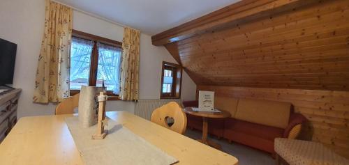 a living room with a table and a couch at Ferienwohnung Zunzer in Mittelberg