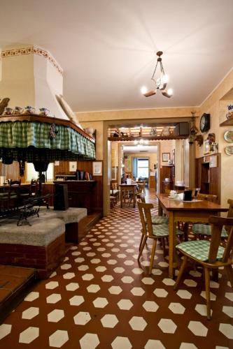 a living room with a table and some chairs at Albergo Centrale Tarcento in Tarcento