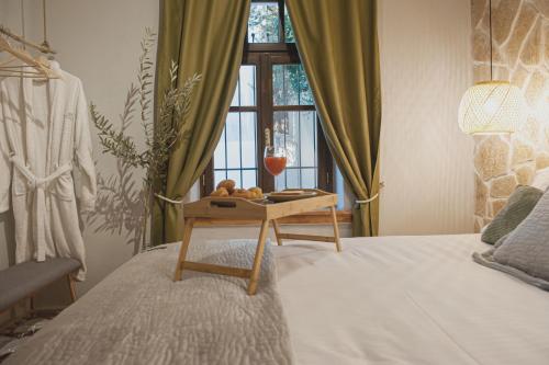 a bedroom with a bed with a table and a window at locanta in Ioannina