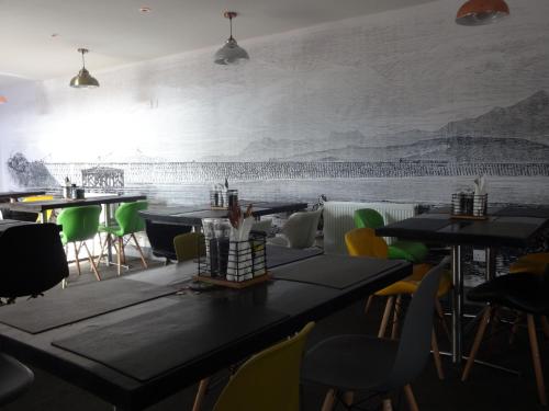 un restaurant avec des tables et des chaises et une fresque murale. dans l'établissement Bowness Bed & Breakfast Double Room, Bowness-on-Solway, à Bowness-on-Solway