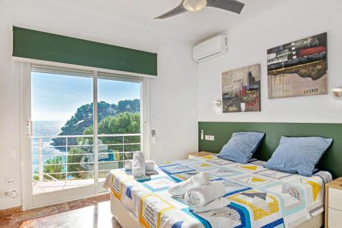 a bedroom with a bed and a large window at Perla del Mar Calpe in Benissa