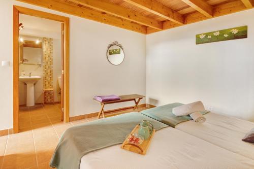 a bedroom with a bed and a bathroom at Calheta Lofts ii in Calheta