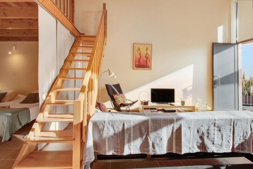 a staircase in a room with a desk and a computer at Calheta Lofts ii in Calheta
