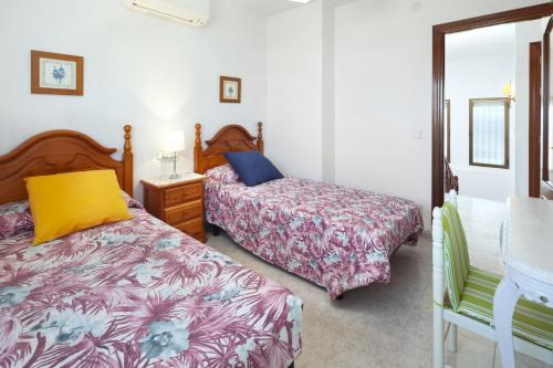 Ліжко або ліжка в номері Villa Jacaranda