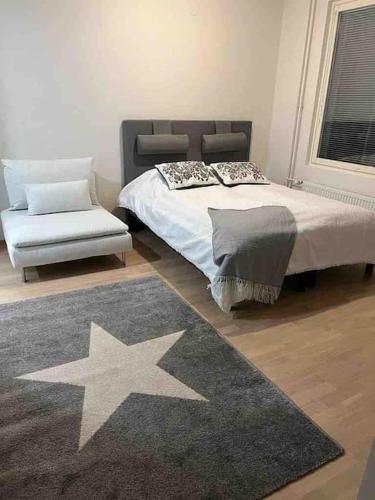 a bedroom with a large bed and a star rug at City apartment nearby Airport in Vantaa
