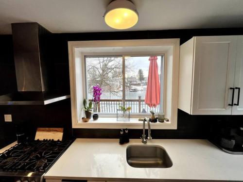 a kitchen with a kitchen sink and a window at Cozy Cabin on the Lake w/ HotTub in Hopatcong