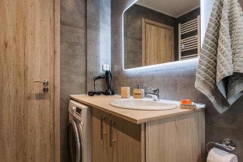 La salle de bains est pourvue d'un lavabo et d'un miroir. dans l'établissement Luxury seaside apartment in Flisvos Palaio Faliro, à Athènes