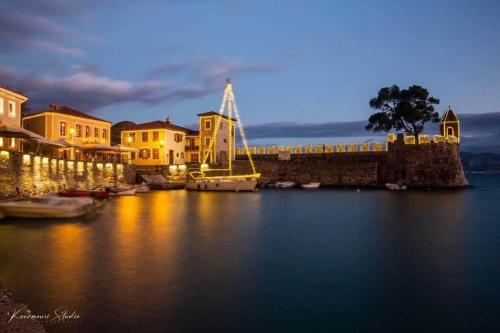 a harbor at night with boats in the water at Vip Lepanto Port Suites in Nafpaktos