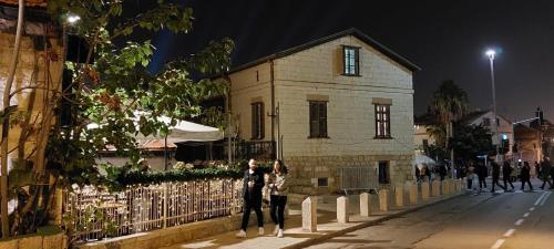 a group of people standing in front of a building at Attic Ben Gurion 42 in Haifa