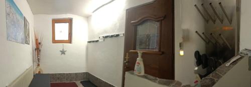a room with a hallway with a door and a window at APPARTEMENT EBERHARTER Conny in Zell am Ziller
