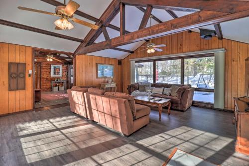 a living room with couches and a ceiling fan at Walk to Lake Harmony Home with Hot Tub and Fire Pit in Lake Harmony