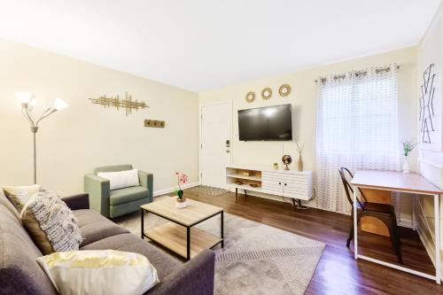 a living room with a couch and a piano at Dapper Digs - King Bed - Long Term Stays - Duke in Durham