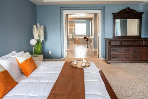 a blue room with a bed and a table at Utopia Luxury Stay in Puyallup
