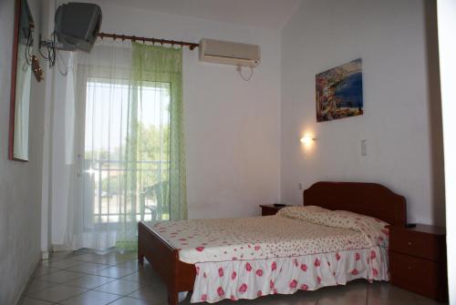 Ένα ή περισσότερα κρεβάτια σε δωμάτιο στο Villa Iris