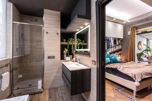 a bathroom with a bed and a sink and a shower at Daphne Luxury Suites in Rome