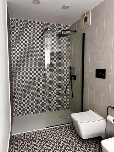 a bathroom with a shower with a toilet and a sink at Toscano Palace Luxury Rooms Catania in Catania