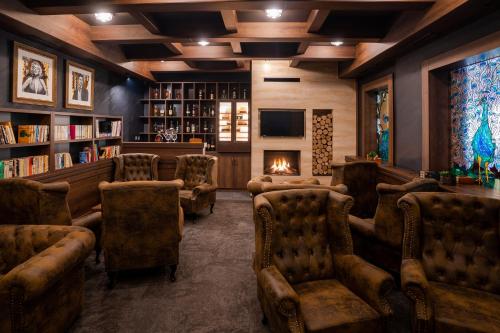 a living room with couches and a fireplace in a library at Hotel Demanova Apartments - Dependance in Liptovský Mikuláš