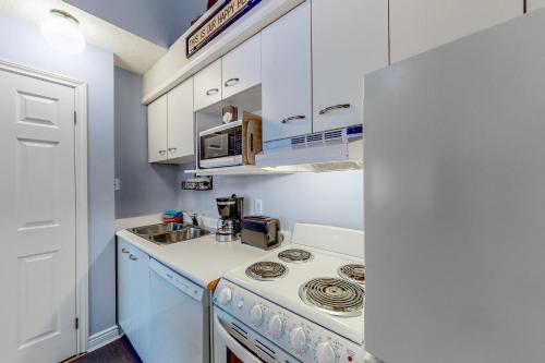 a kitchen with a stove and a sink at Condo 110 at North Creek Resort in Blue Mountains